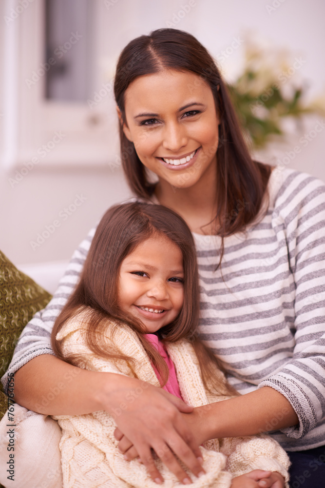 Living room, mom and daughter with hug for love in home with smile, care and happiness. Apartment, woman and girl together for bonding in lounge to relax on couch or sofa for mothers day in weekend