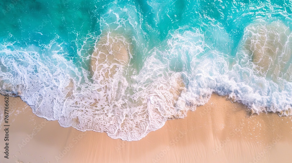 Summer seascape beautiful waves, blue sea water in sunny day. Top view from drone. Sea aerial view, amazing tropical nature background. Beautiful bright sea waves splashing and beach sand sunset light