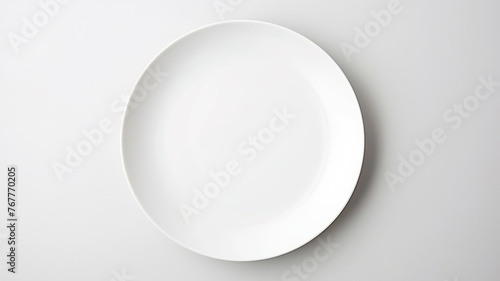 A white empty round plate on a white background, an image with copy space