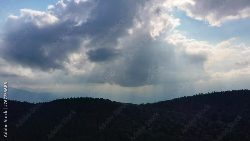 Aerial view of deep forest, mountains, clouds and sun rays. Aerial view of deep forest, mountains, clouds and sun rays.