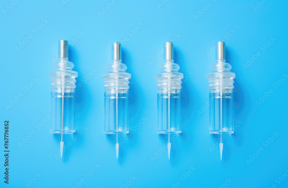 Medical syringe, vials with coronavirus vaccine on light blue background, flat lay., top view. Copy space for text Medical syringe, vials with coronavirus vaccine on light blue background, flat lay., top view. Copy space for text