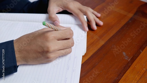 the hand that is writing in the book