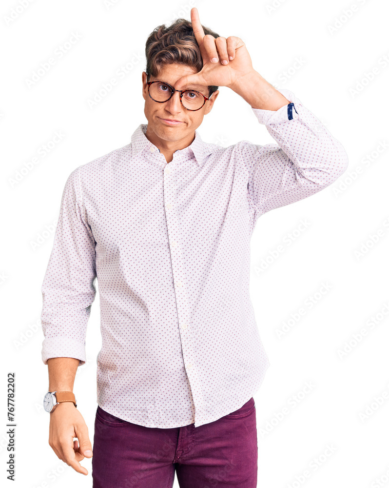 Young handsome man wearing business clothes and glasses making fun of people with fingers on forehead doing loser gesture mocking and insulting. Young handsome man wearing business clothes and glasses making fun of people with fingers on forehead doing loser gesture mocking and insulting.