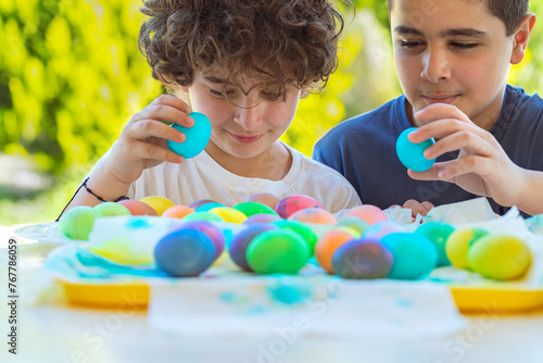 Two Happy Boys Playing with Colorful Easter Eggs