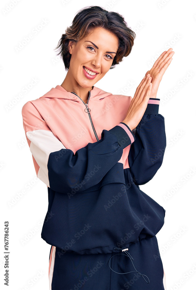 Young beautiful woman wearing sportswear clapping and applauding happy and joyful, smiling proud hands together Young beautiful woman wearing sportswear clapping and applauding happy and joyful, smiling proud hands together