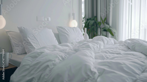 Cozy unmade bed bathed in soft morning light showcasing casual comfort in a modern home. photo