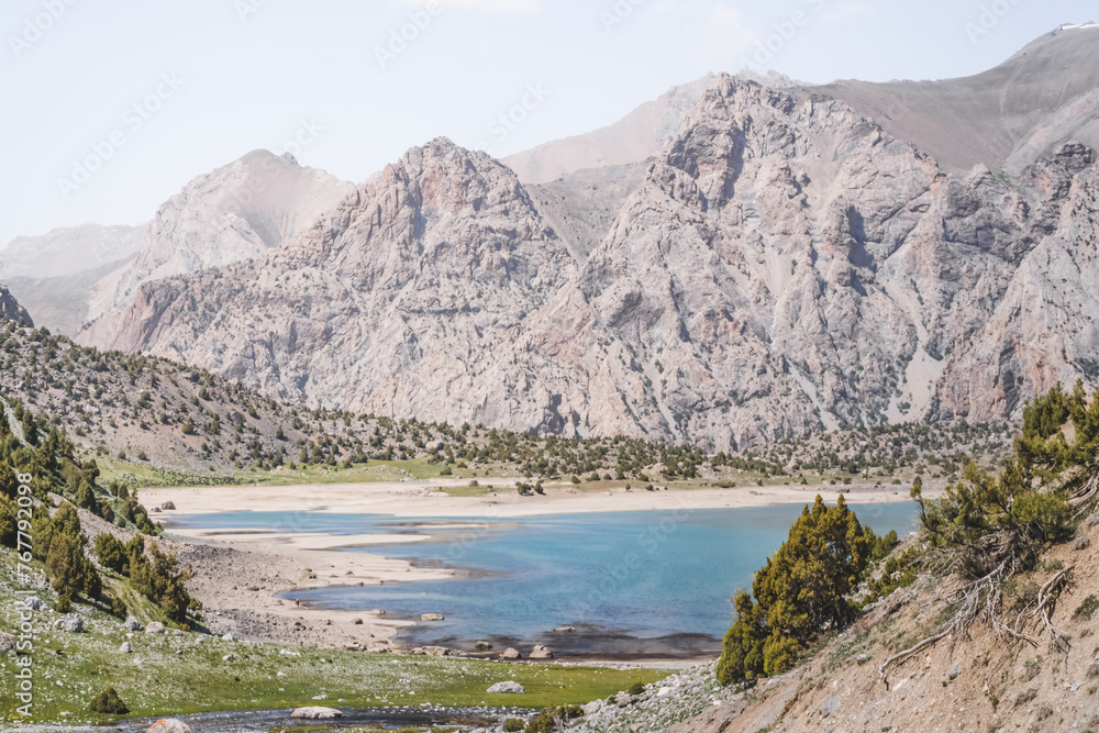 View of Lake Kulikalon and the Kulikalon Basin from a mountainside in the Fan Mountains in Tajikistan, atmosphere in the Tien Shan highlands View of Lake Kulikalon and the Kulikalon Basin from a mountainside in the Fan Mountains in Tajikistan, atmosphere in the Tien Shan highlands