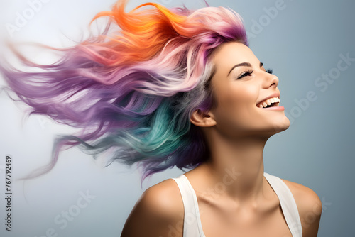 Woman with colorful hair on gray background