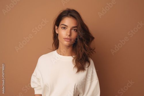a minimalist beige backdrop highlighting the grace of a model girl, capturing the essence of modern fashion.