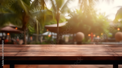 Perspective wood and bokeh light background empty wooden table top with blur background of rain forest with summer palm tree