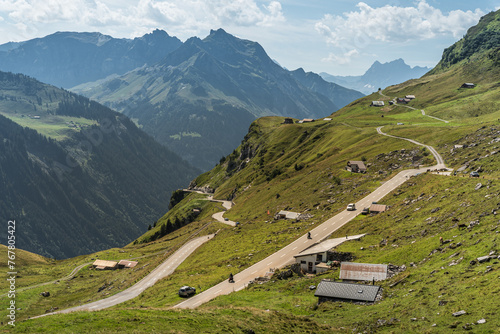 Mountain landscape with pass road and huts at Klausen Pass, Unterschaechen, Canton of Uri, Switzerland