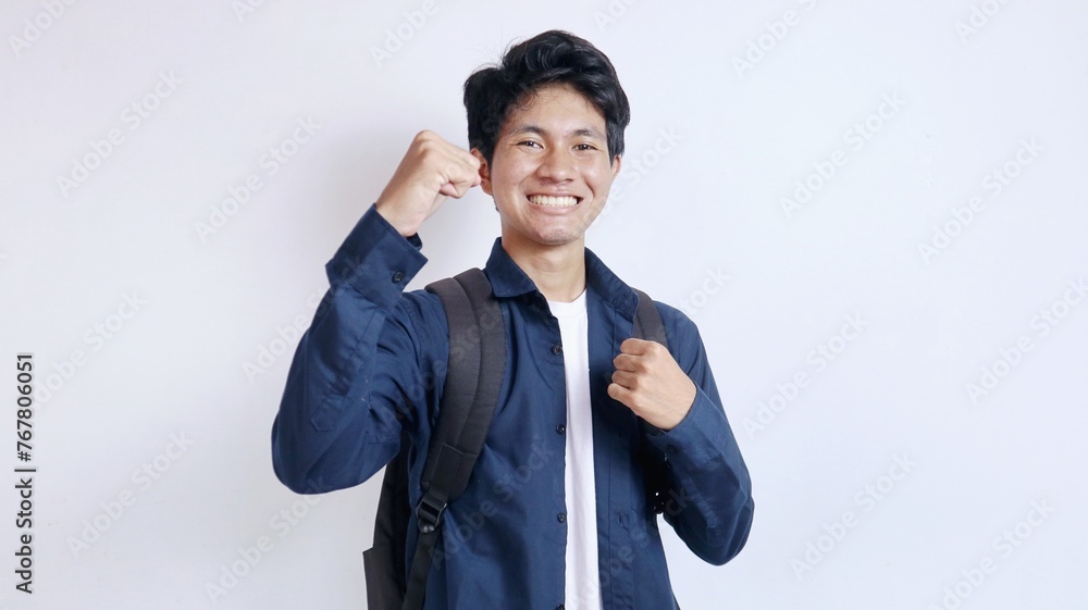 portrait of young handsome Asian student excited on isolated white background portrait of young handsome Asian student excited on isolated white background