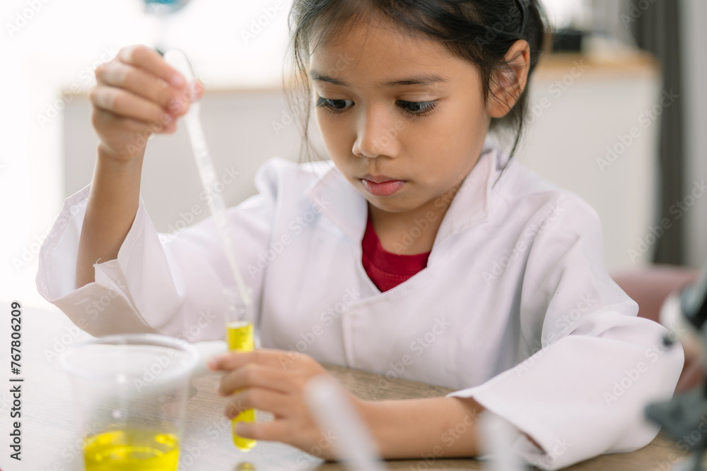 Asian girl doing chemical experiments at the lab Asian girl doing chemical experiments at the lab