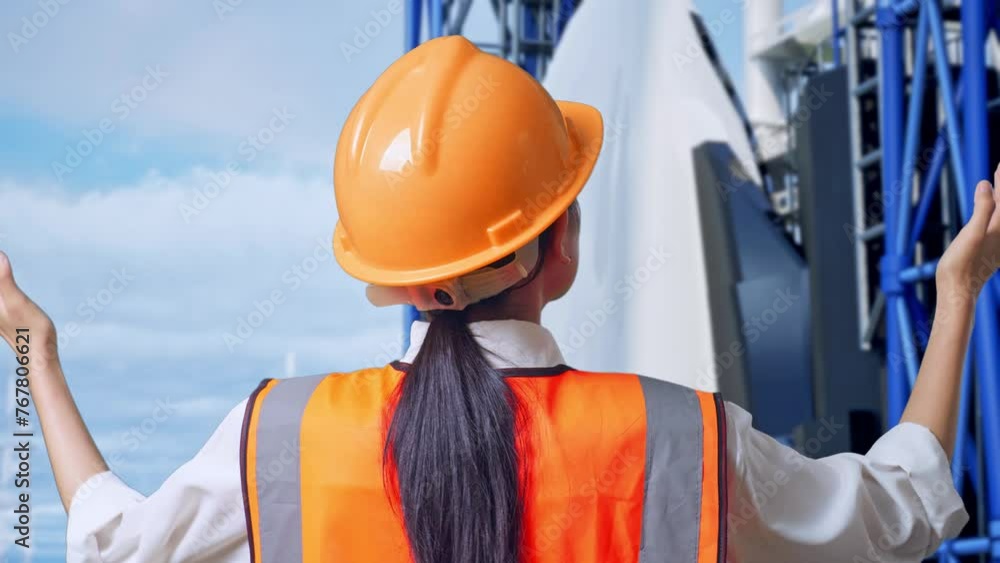Close Up Back View Of A Female Engineer With Safety Helmet Spreading Arms While Standing With Space Shuttle Close Up Back View Of A Female Engineer With Safety Helmet Spreading Arms While Standing With Space Shuttle