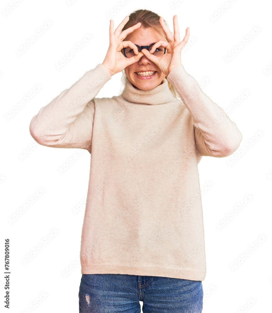 Fototapeta premium Young beautiful blonde woman wearing turtleneck sweater and glasses doing ok gesture like binoculars sticking tongue out, eyes looking through fingers. crazy expression.