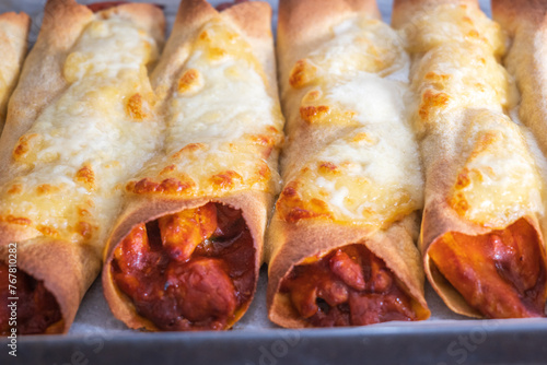 Cooked and ready to eat homemade mexican enchiladas on baking oven tray