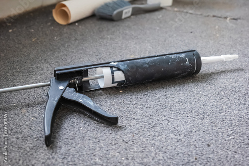 Used sealant cartridge gun on carpet floor in england uk