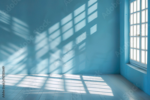 Blue background with shadows of window on the floor