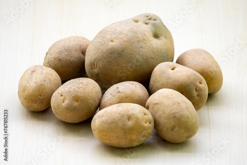 Fresh raw potatoes on a wooden background. In the Bengali language  it is called Aloo or Alu.