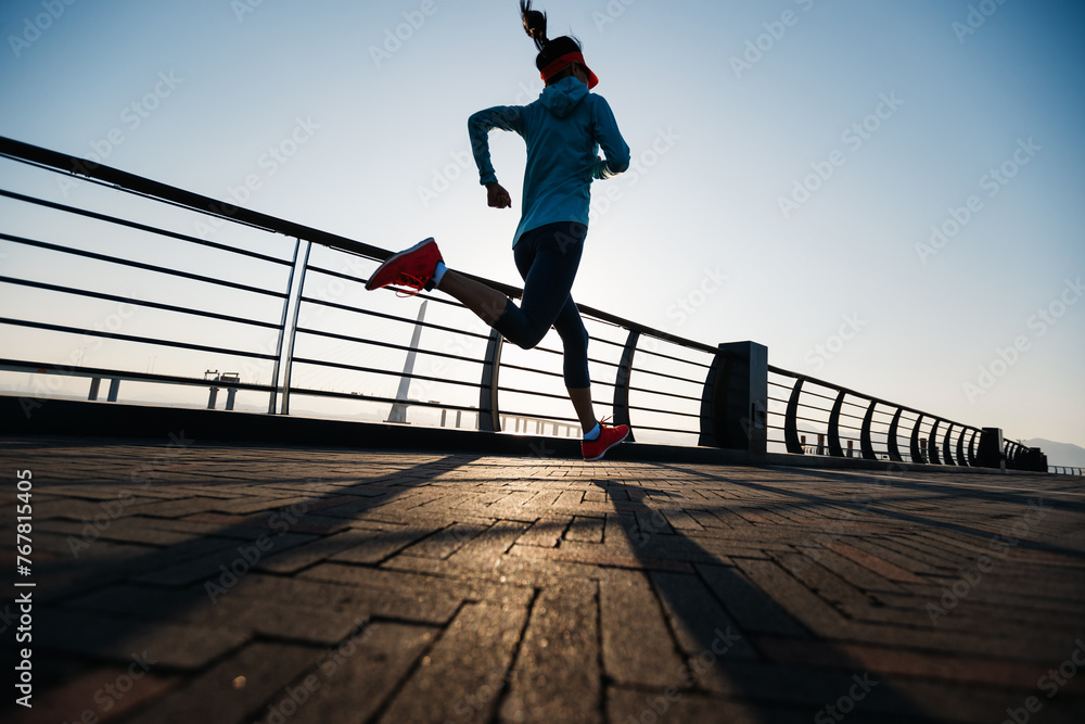 Fitness woman runner running at seaside