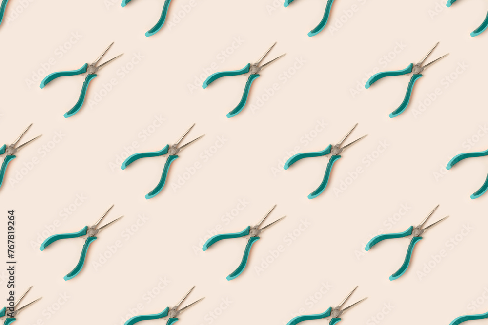 Repetitive pattern made of needle-nose pliers on a beige background. Repetitive pattern made of needle-nose pliers on a beige background.