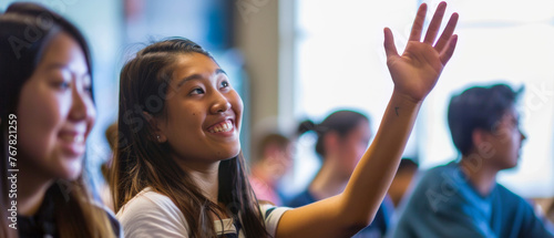 Eager female student raising hand in a classroom full of peers.