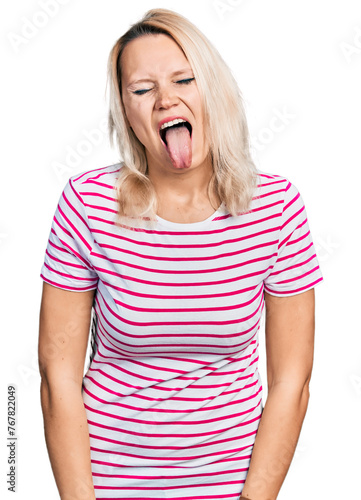 Young caucasian woman wearing casual clothes sticking tongue out happy with funny expression. emotion concept.