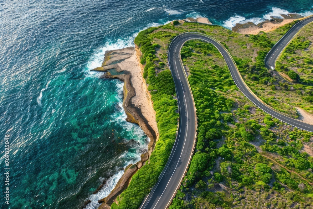 A winding road with a beautiful ocean view in the background