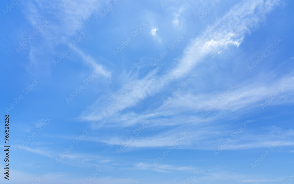 Fotografie Blue sky with beautiful wispy clouds. Abstract sky background.