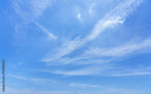 Fotografie Blue sky with beautiful wispy clouds. Abstract sky background.