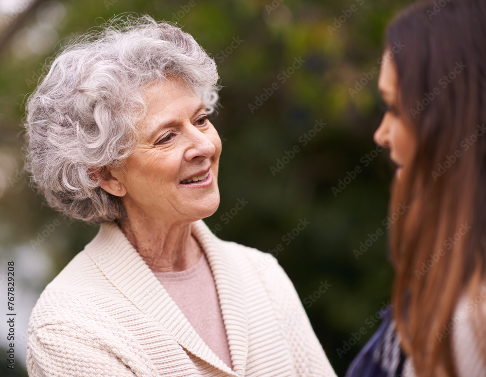Senior woman, mother and daughter with smile for love, bonding and visit from relatives outdoor in backyard, garden and patio. Elderly female person, young lady and family bonding together in Italy