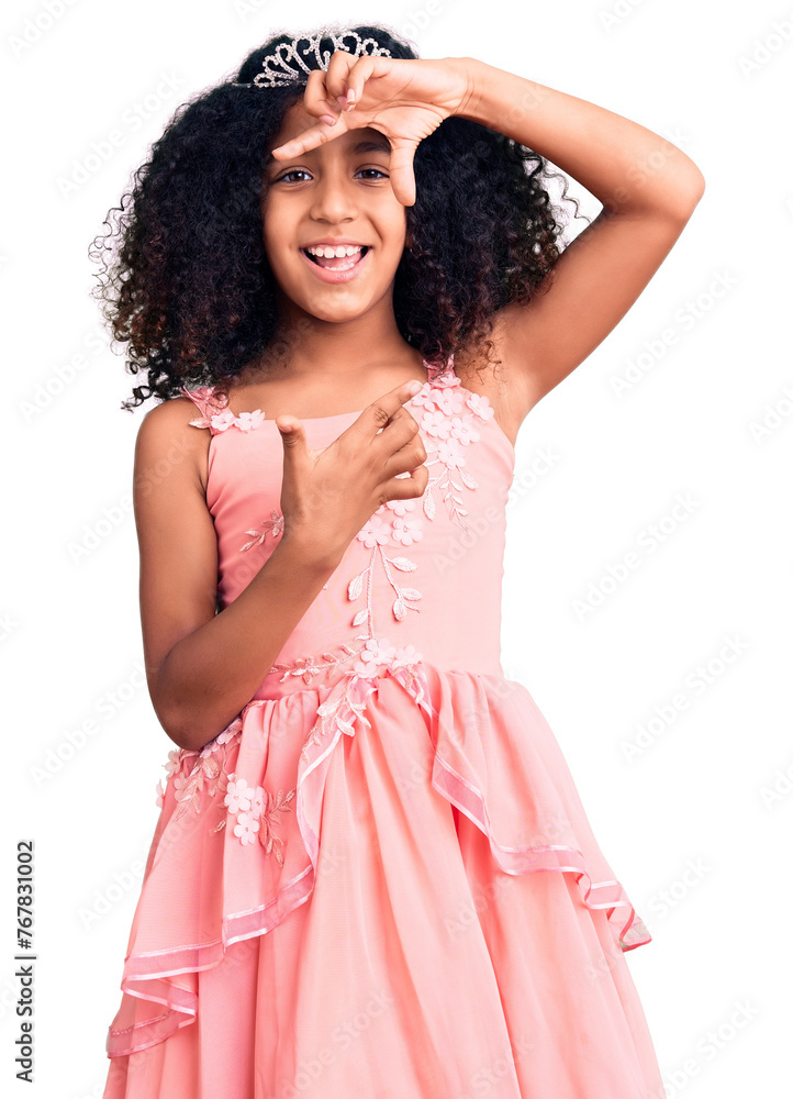 African american child with curly hair wearing princess crown smiling making frame with hands and fingers with happy face. creativity and photography concept. African american child with curly hair wearing princess crown smiling making frame with hands and fingers with happy face. creativity and photography concept.
