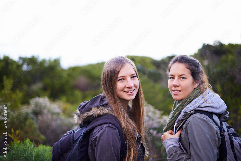 Portrait, women and hiking in nature for adventure, workout or exercise as fitness routine in forest. People, green plants and trees in Denmark for walking journey in woods or bush in countryside