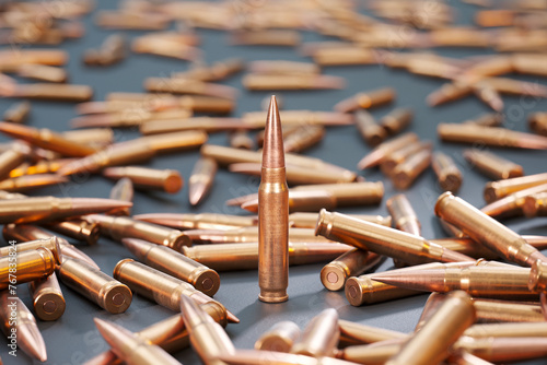 Close-Up View of Scattered Bullet Cartridges on a Vibrant Blue Surface