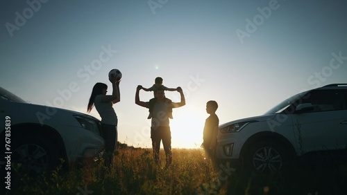 happy family play ball next to car silhouette a camping vacation. Road trip fun. happy family adventures with car travel and camping silhouette. car travel and silhouette camping expedition sunset