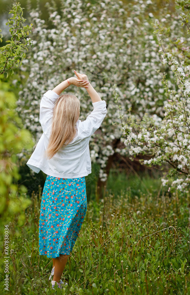Vinnytsia, Ukraine. May 5, 2023: A girl in a blooming garden. Green dress. Spring. Easter is coming soon Vinnytsia, Ukraine. May 5, 2023: A girl in a blooming garden. Green dress. Spring. Easter is coming soon
