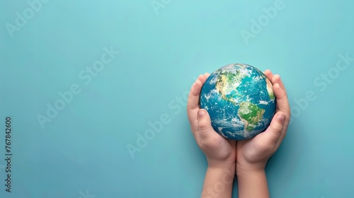 World Earth Day Concept. Green Energy, ESG, Renewable and Sustainable Resources. Environmental Care. Hands of People Embracing a Handmade Globe. Protecting Planet Together. Top View eco care ecology