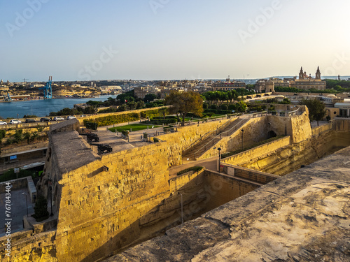 Valletta, Malta - August 8th 2021: Saint James Counterguard is a pentagonal counterguard built in 1640. In the background is the Grand Harbour. photo