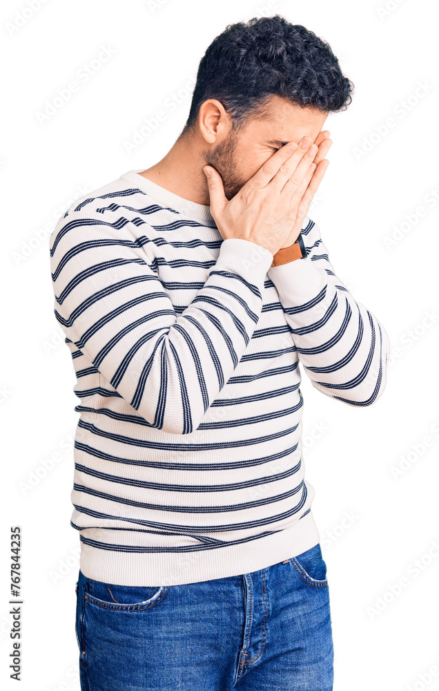Young hispanic man wearing casual clothes with sad expression covering face with hands while crying. depression concept. Young hispanic man wearing casual clothes with sad expression covering face with hands while crying. depression concept.