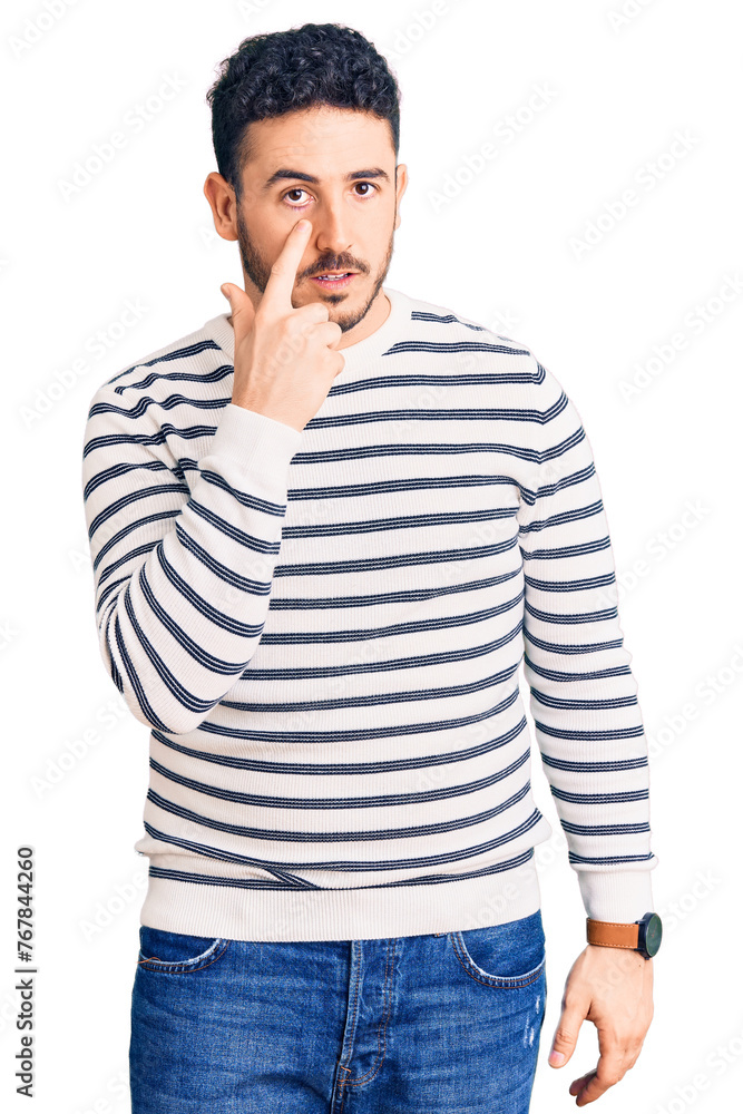 Young hispanic man wearing casual clothes pointing to the eye watching you gesture, suspicious expression Young hispanic man wearing casual clothes pointing to the eye watching you gesture, suspicious expression
