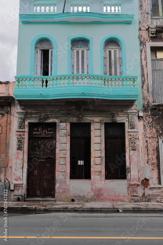 Neatly painted first floor of 1900s Eclectic style house contrasting with a chipped ground floor facade, San Lazaro Street. Havana Centro-Cuba-116