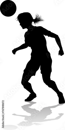 A female soccer football player woman in silhouettes