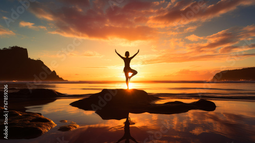 A silhouette of a woman with arms raised in a gesture of freedom and joy stands on the beach