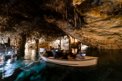 People in the boat on lake in amazing Drach Caves in Mallorca, Spain, Europe photo