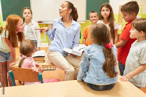 Teacher pointing at girl leaning on bench