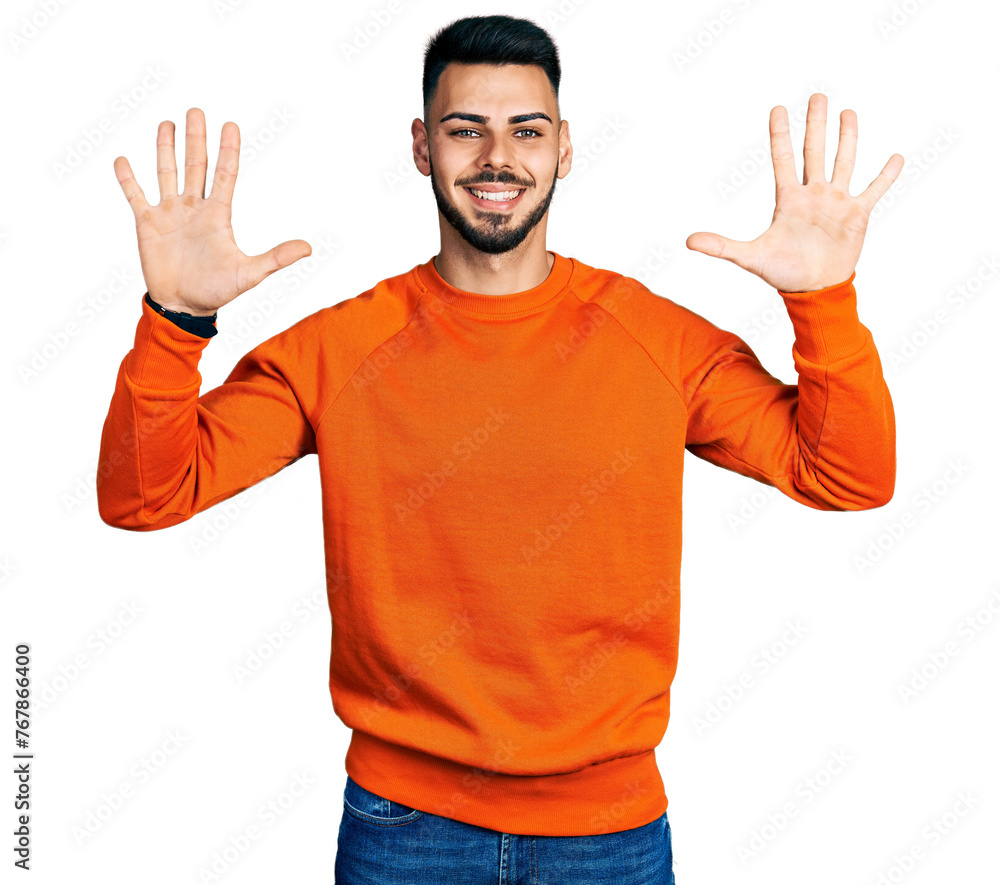 Young hispanic man with beard wearing casual orange sweater showing and pointing up with fingers number ten while smiling confident and happy. Young hispanic man with beard wearing casual orange sweater showing and pointing up with fingers number ten while smiling confident and happy.