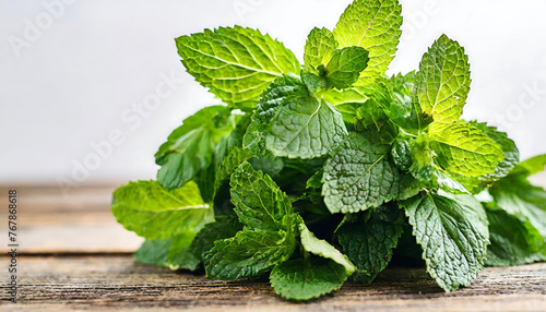 A Bundle of Fresh and Green Mint Leaves on wooden table for Healthy Nutrition
