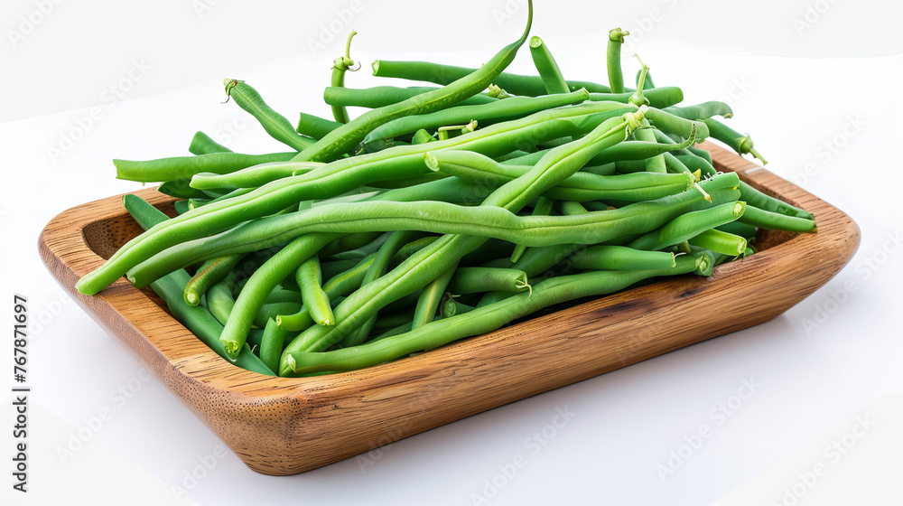 Green beans in a wooden plate on a white background Green beans in a wooden plate on a white background