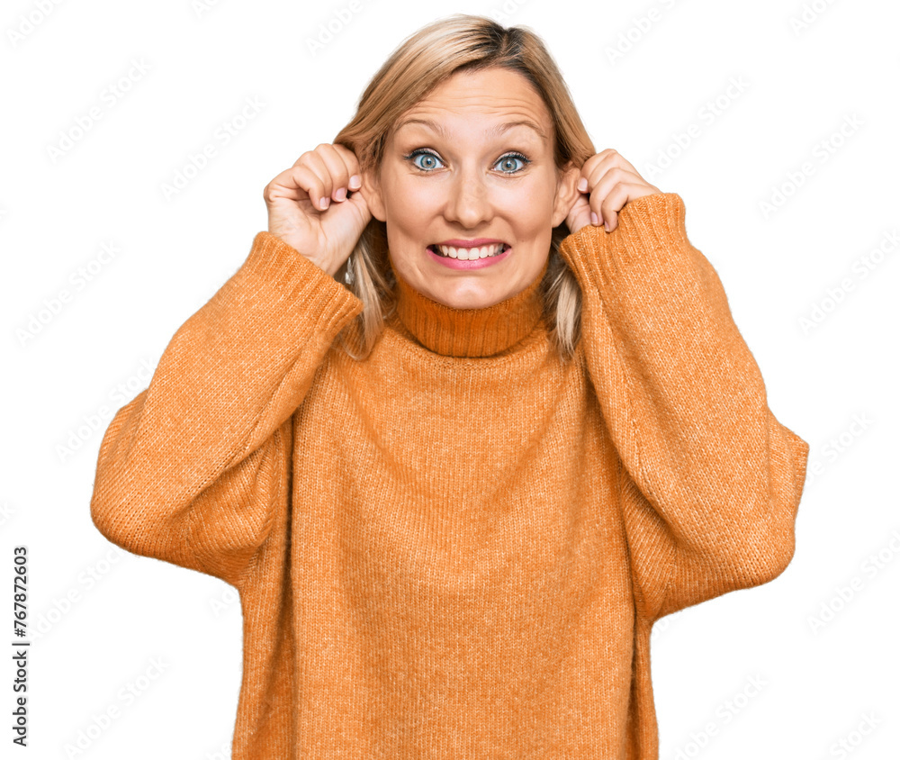 Middle age caucasian woman wearing casual winter sweater smiling pulling ears with fingers, funny gesture. audition problem Middle age caucasian woman wearing casual winter sweater smiling pulling ears with fingers, funny gesture. audition problem
