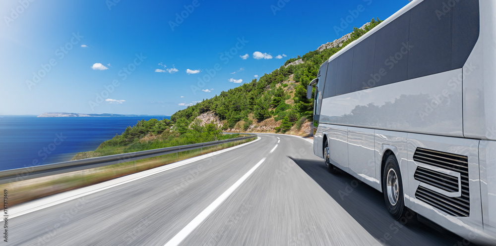Tourist bus on a mountain road by the sea. Tourist travel concept.